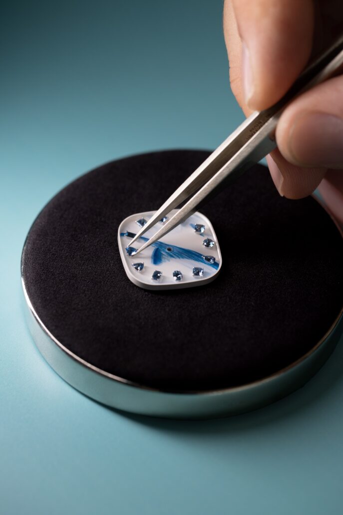 An artisan sets the dial with aquamarine indexes Craft@TiffanyCo