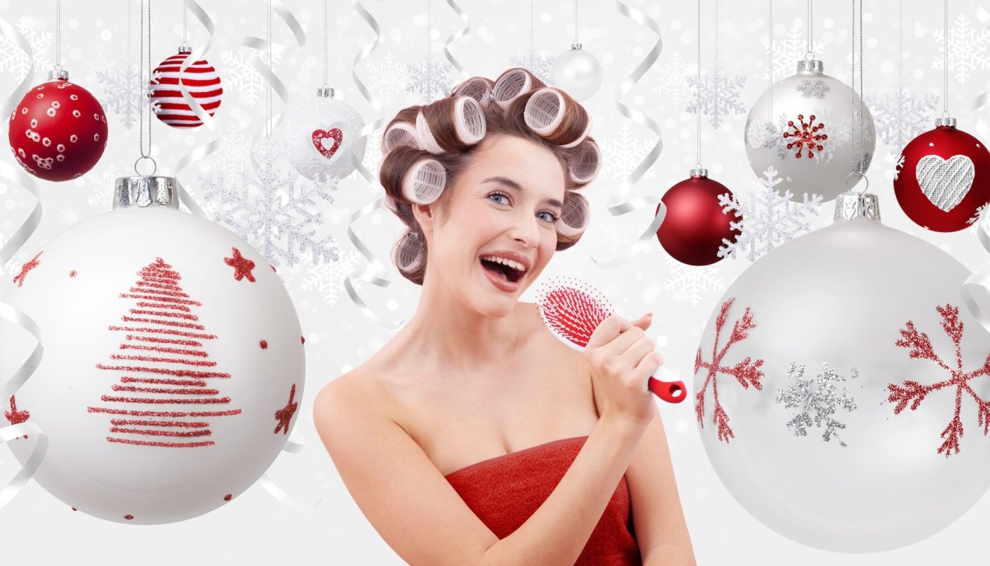 Happy Merry Christmas, woman with hair curlers singing into a hairbrush, surrounded by Christmas balls with trees, and snowflakes. Concept of beauty, and makeup products. Isolated on white background